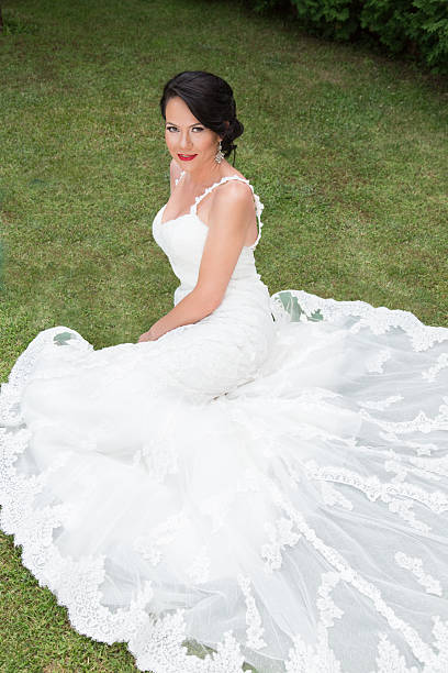 istock Beautiful Bride sitting on the grass 514032361