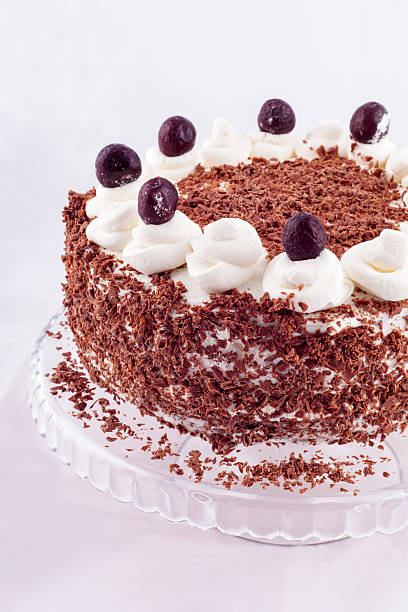 istock Black forest cake decorated with whipped cream and cherries. 514047160