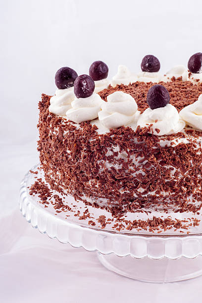 istock Black forest cake decorated with whipped cream and cherries. 514047276