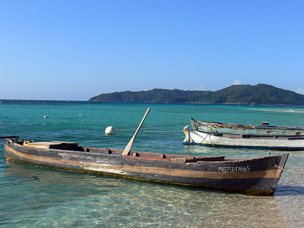 Cayos Cochinos, Honduras - March 12, 2012:  View of transparent waters and fishermen boats in Cayo Chachauate, archipelago of Cayos Cochinos, location of Italian and Spanish Celebrity Survivor