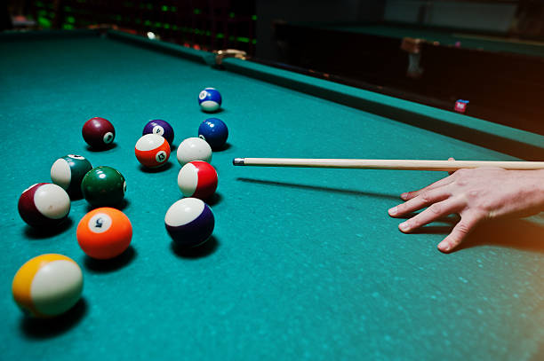 istock Hand man holding billiard cue to shoot balls 514048092