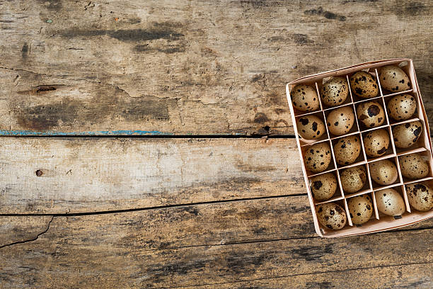 istock Easter wood background with box of quail eggs 514048862