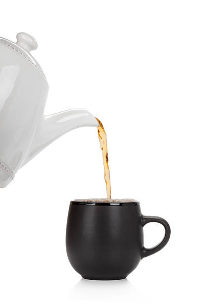 istock Pouring tea into a cup isolated on white 514050592