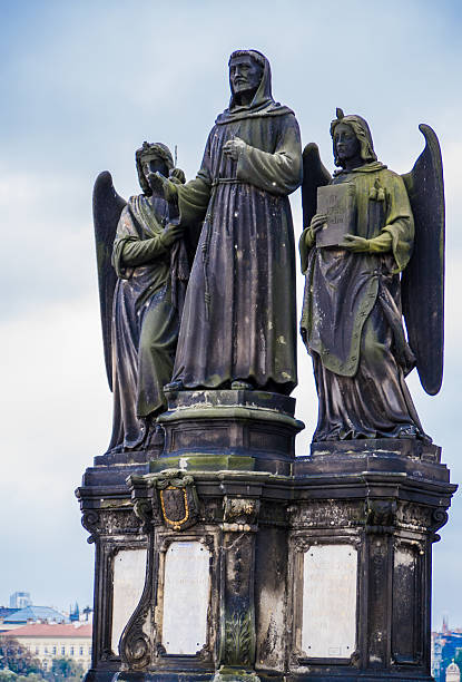 istock Statue St. Francis of Assisi with two seraphims, guardian angels 514050652