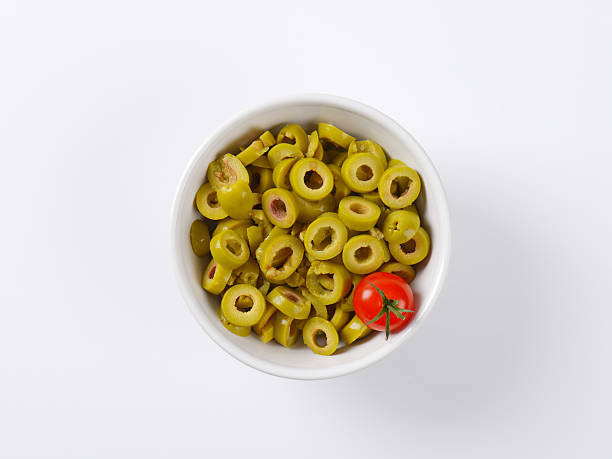 sliced green olives bowl of sliced green olives green olive stock pictures, royalty-free photos & images