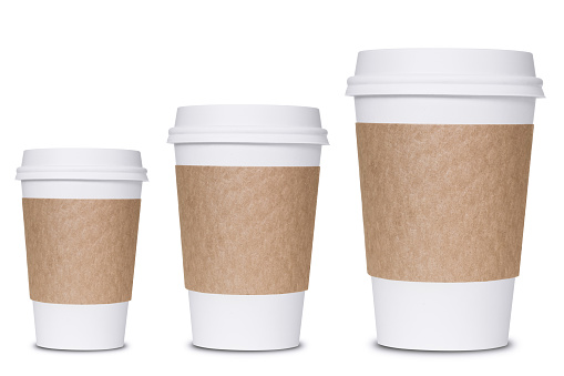 Photograph of three coffee cup sizes isolated on white background.