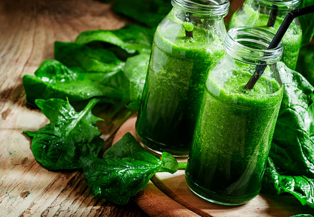 istock Healthy spinach smoothies, detox drink in glass bottles 514055846