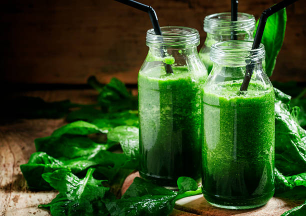 istock Healthy spinach smoothies, detox drink in glass bottles 514056290