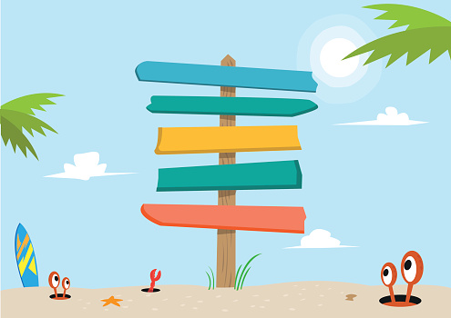 A blank and colorful signboard made of planks stands in the middle of a beach sand.  
