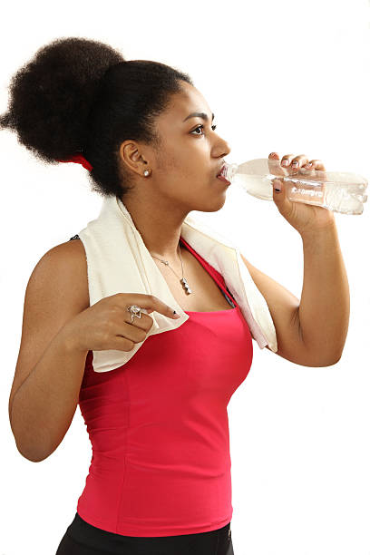 istock black girl drinks water from a bottle 514057846