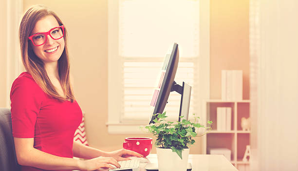 istock Happy young woman on her computer in her home office 514057864