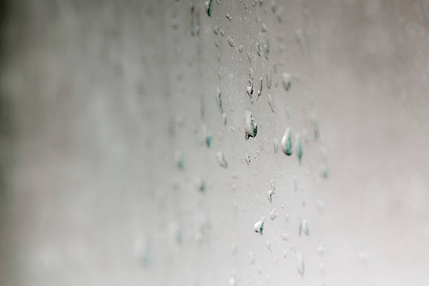 istock Water drops pouring on a grey transparent glass 514058602