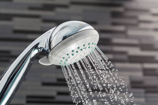 istock Shower head with water drops falling on a bathroom 514058648