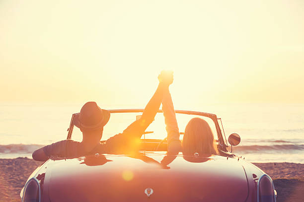 istock Couple watching the sunset in a convertible car. 514059110