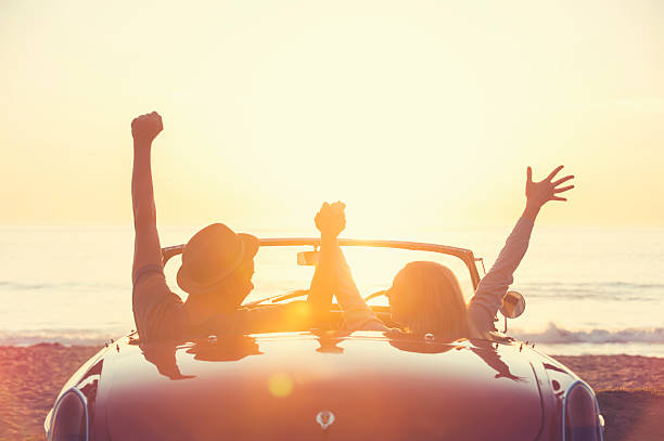 istock Couple watching the sunset in a convertible car. 514059262