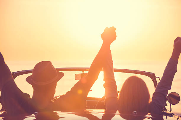 istock Couple watching the sunset in a convertible car. 514059320