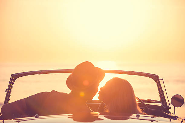 istock Couple watching the sunset in a convertible car. 514059398