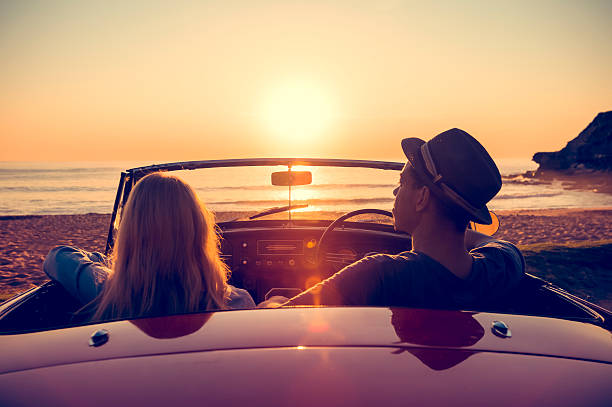 istock Couple watching the sunset in a convertible car. 514059480