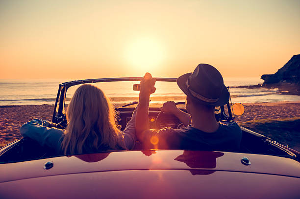 istock Couple watching the sunset in a convertible car. 514059640
