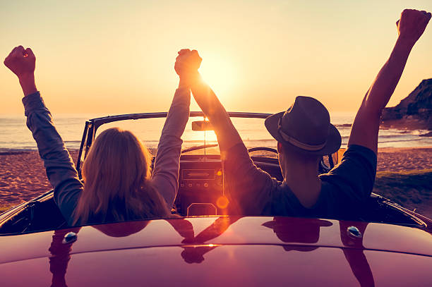 istock Couple watching the sunset in a convertible car. 514059716