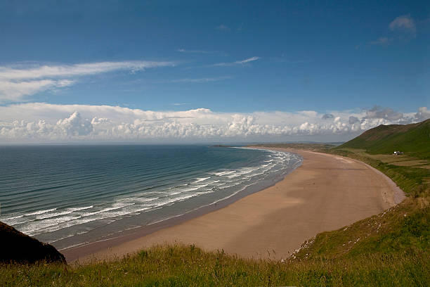 Rhossili Beach, Gower Peninsular. Rhossili beach is a favourite spot on the Gower Peninsular to visit. With its wide open views and spectacular curves it is visual feast. gower peninsular stock pictures, royalty-free photos & images