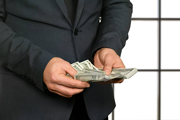 istock Adult office worker counting cash. 514061900