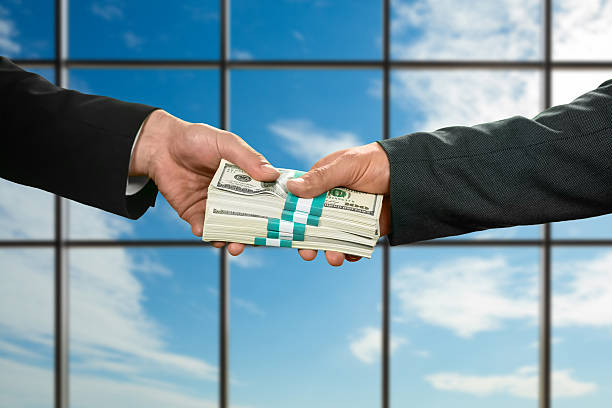 istock Businessman takes big money. 514062132