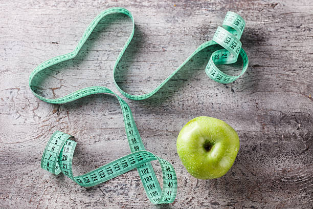 Green Apple and centimetre Green Apple and centimetre.Food or Healthy diet concept.selective focus. centimetre stock pictures, royalty-free photos & images