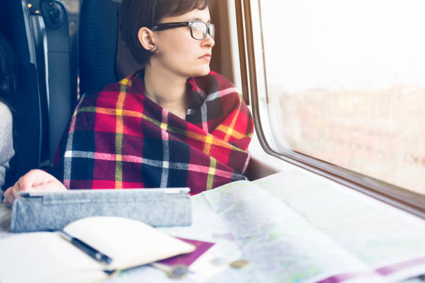 istock Young woman looking out from a train coach 514065980