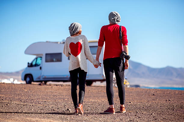 istock Couple traveling by camping trailer 514066924