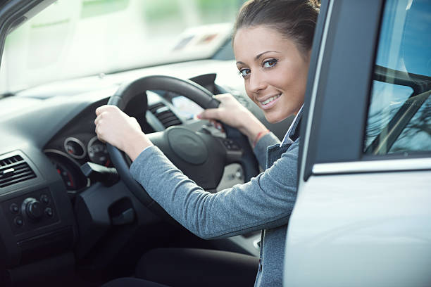 istock Smiling woman driving a car 514067032