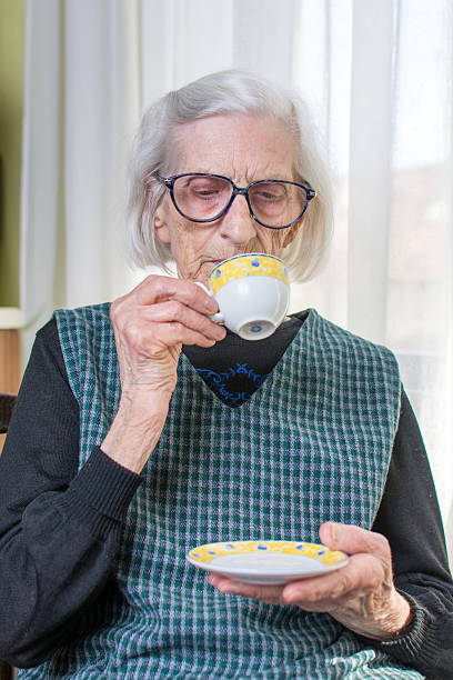 istock Grandma having cup of coffee indoors 514067266