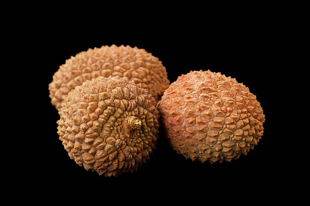 istock Three lychee fruits isolated on a black background 514067976