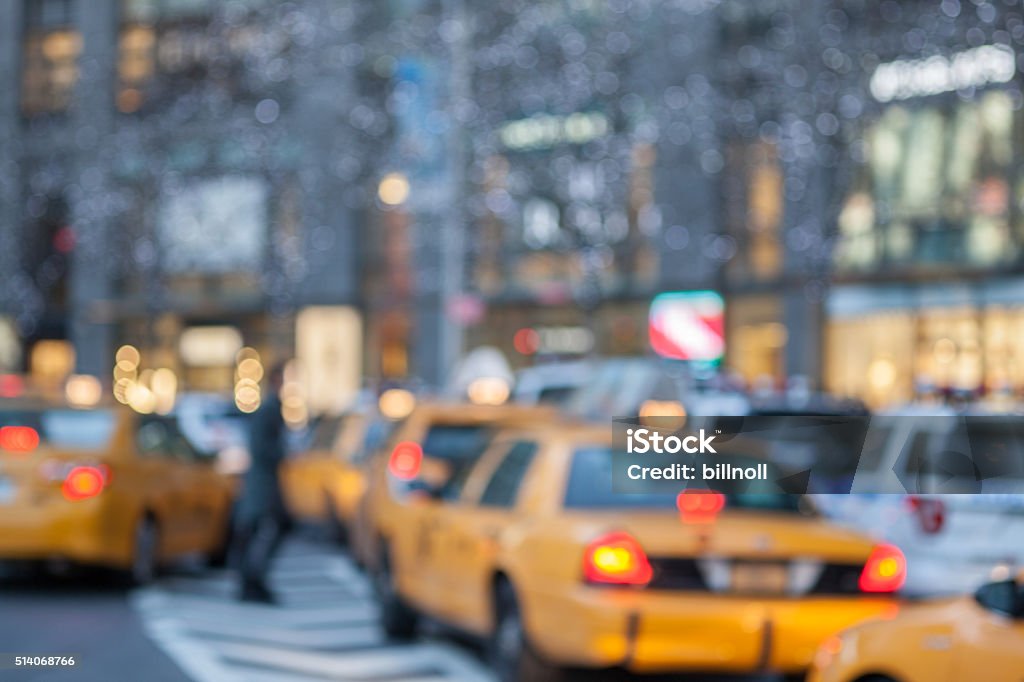Defocused early evening street scene in New York City Defocused early evening street scene with taxi cabs in Uptown Manhattan, New York City. Slight grain effect in shadow areas. Location is near Columbus Circle. Abstract Stock Photo