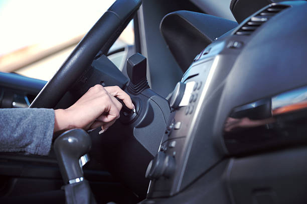 Woman starting car engine Female driver hand inserting car key and starting engine. ignition photos stock pictures, royalty-free photos & images