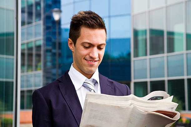 istock Smiling young businessman standing outside a building 514073317