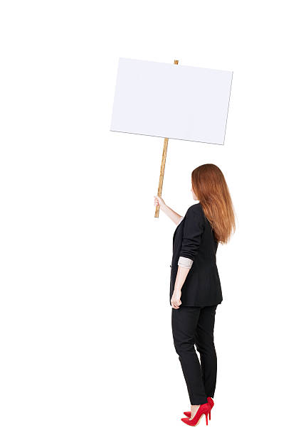 istock Back view business woman showing sign board. 514075259