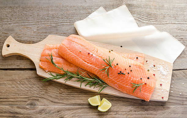 istock Raw salmon steaks on the wooden board 514076033