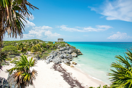 View towards the ancient Mayan God of Winds Temple close the Pyramid El Castillo at the caribbean coast of Tulum, Mexico.