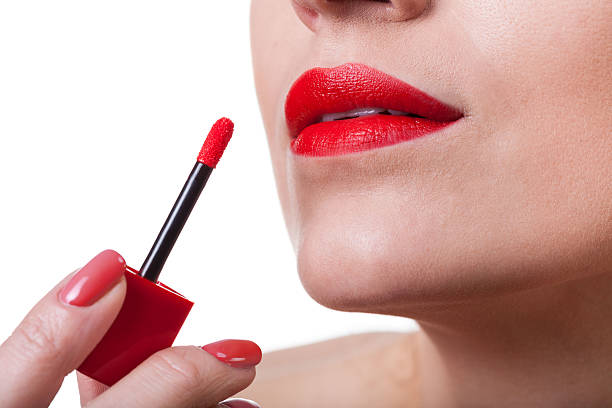 istock Painting lips with red lipstick 514079511