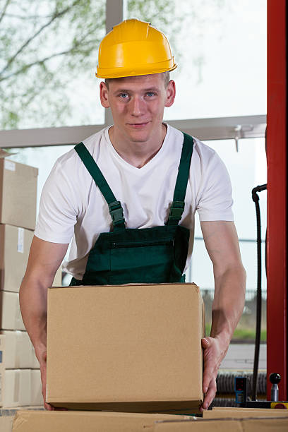 istock Portrait of a warehouse worker lifting a box 514079579