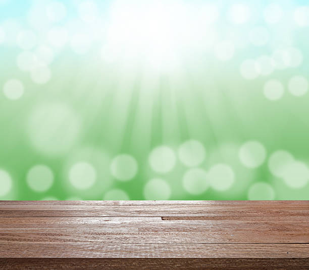 istock Wood table top on green blurred bokeh light 514099710