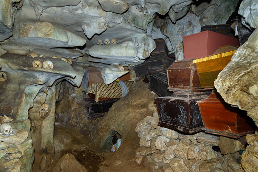 Skulls and coffins in cave. Londa is cliffs and cave old burial site in Tana Toraja. Galleries of tau-tau on balcony guard the graves. Inside there's a collection of coffins. South Sulawesi, Indonesia