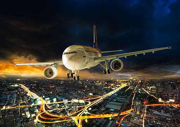 istock Airplane over night scene city 514102882