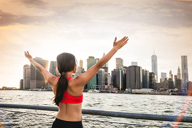 istock Young woman runner with arms raised 514103165