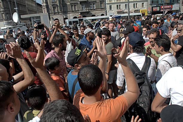 Syrian refugees Budapest, Hungary - September 1, 2015: War refugees gather in Budapest on their way to a new and safe life. Refugee crises increase in Europe as more and more people have to leave their Middle-eastern home because of the threat of the Islamic State. militant groups photos stock pictures, royalty-free photos & images