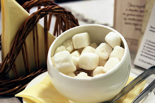 Sugar. Sugar cubes. Sugar-bowl. Sugar-basin. Shallow depth of field.