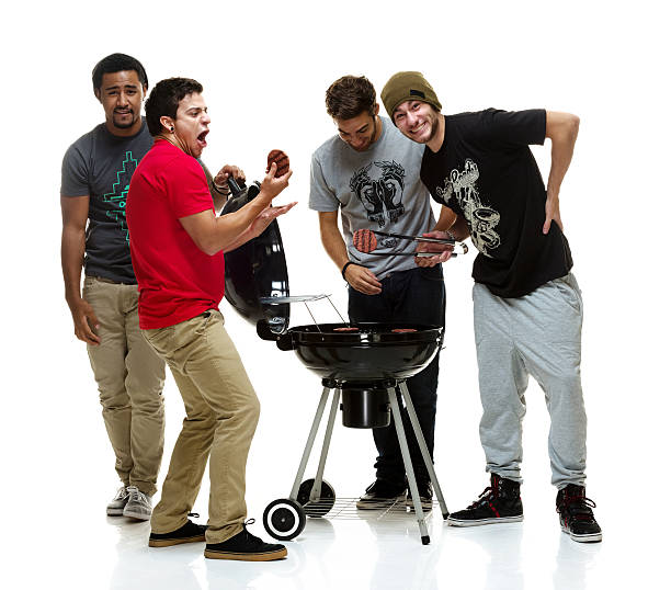 Social group of young men having a BBQ