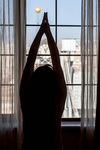 istock girl practicing yoga in front of window 514104822