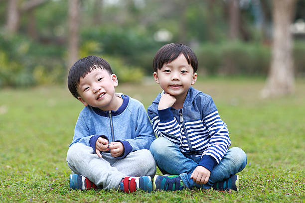 istock Two brothers play in the park 514105170